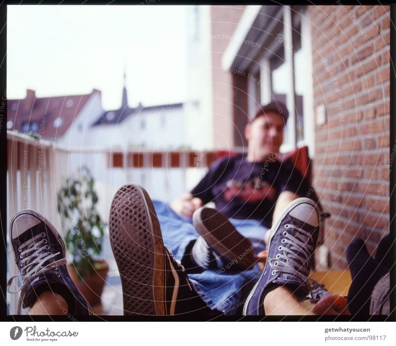 Bad manners Footwear Man Balcony Summer Beautiful weather Plant Brick Wall (building) Chucks Shoe sole Table Window Relaxation Weekend Leisure and hobbies Joy