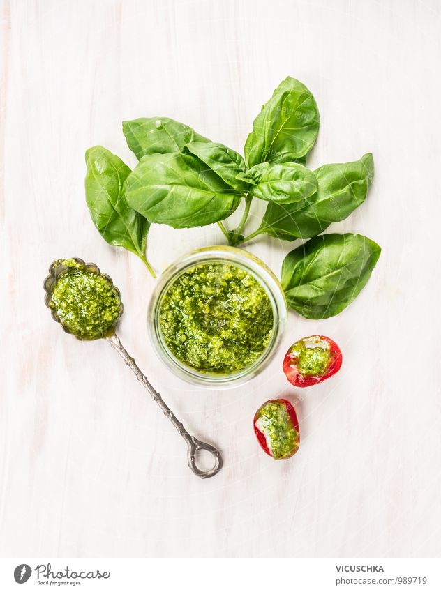 Basil pesto in a glass with spoon and tomatoes Food Vegetable Herbs and spices Cooking oil Nutrition Organic produce Vegetarian diet Diet Italian Food Crockery