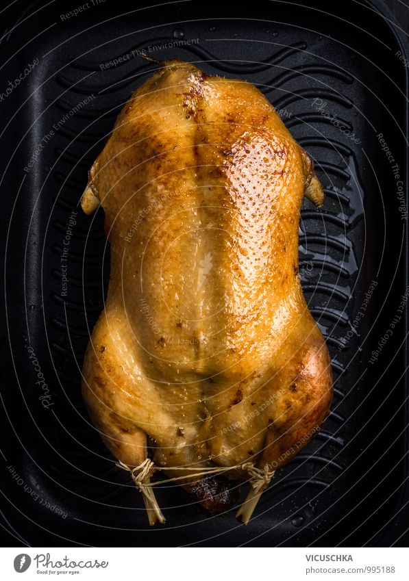 Roast duck on black baking tray Food Meat Cooking oil Nutrition Banquet Organic produce Crockery Style Design Feasts & Celebrations Duck roast duck Tradition