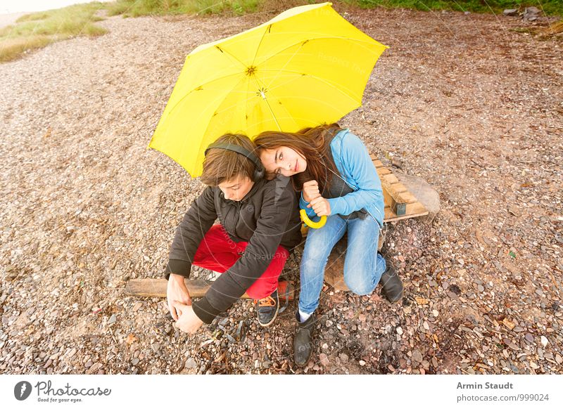 Brother and sister under a yellow umbrella on the beach Lifestyle Relaxation Trip Human being Masculine Feminine Brothers and sisters Couple