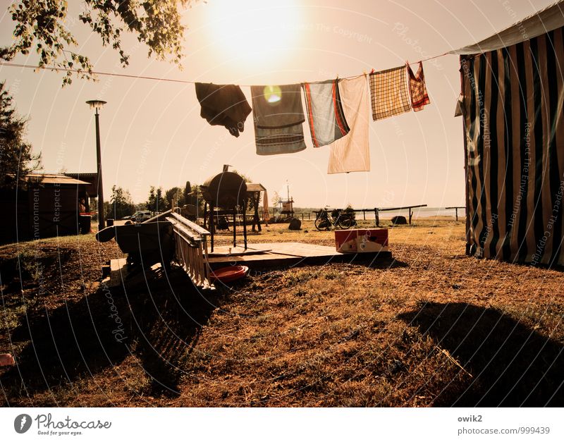 After washing the dishes Beer tent Clothesline Dish towel Dry Lamp post Movement Hang Illuminate Happiness Bright Warmth Calm Idyll Closing time Judder Lawn