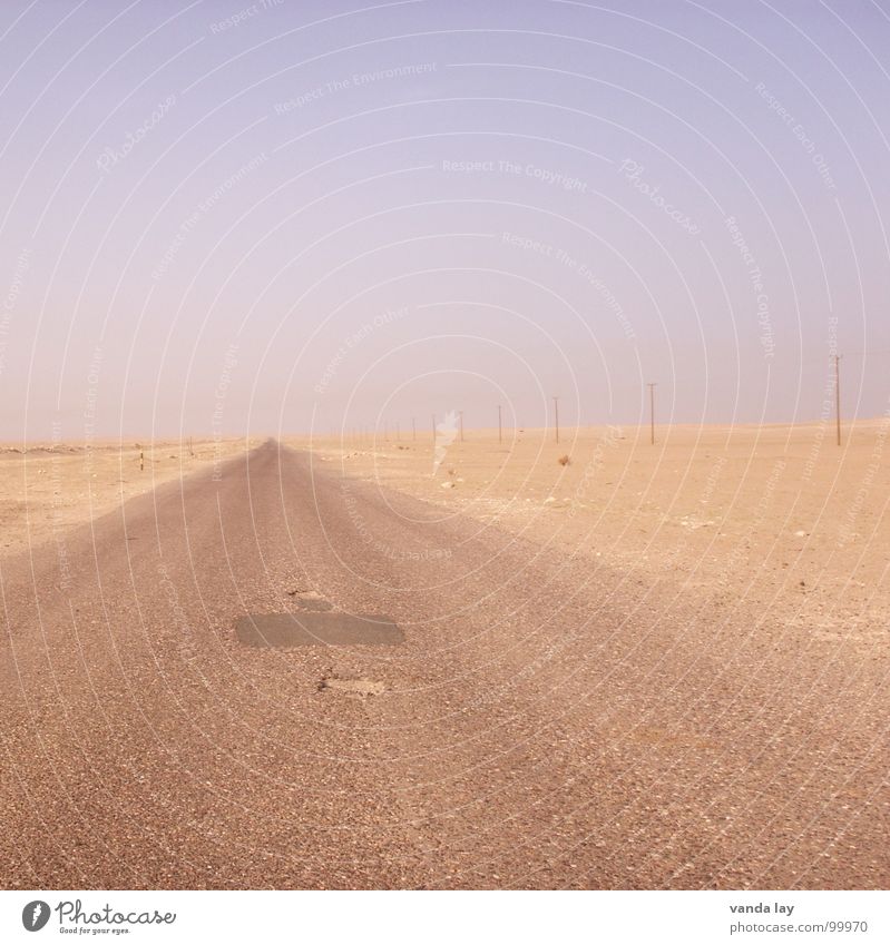 Highway to Hell Iraq War Loneliness Empty Horizon Basra Asphalt Pothole Electricity pylon Right ahead Vanishing point Traffic infrastructure Desert Boredom